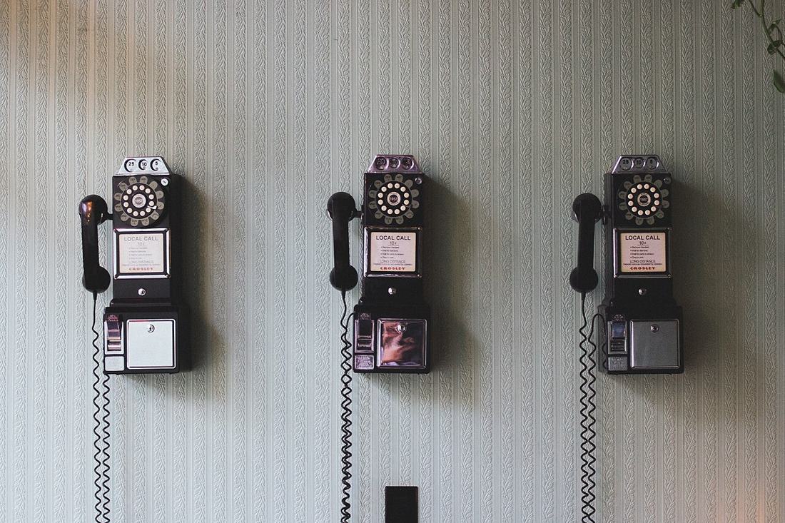 A vintage telephone on a wall.